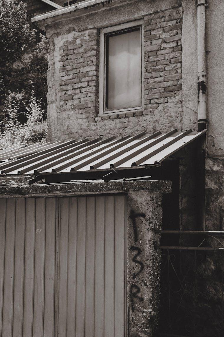 Weathered residential garage door on a brick house in the Portland metro area
